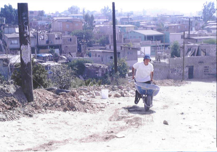 Voluteer mans wheel barrow Colonia La Esperanza Tijuana