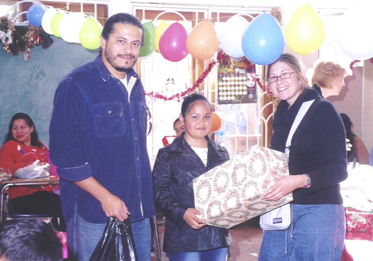 UCSD's Neuro Science Dept's Mike Baca and Tanya Levi help distribute Christmas presents at Colegio La Esperanza Xmas 2003